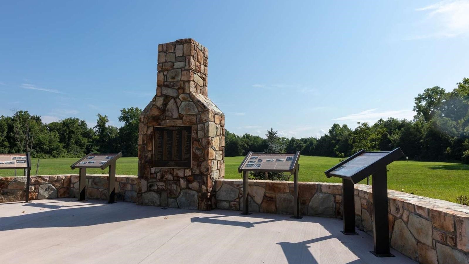 A stone chimney with a brass plaque.