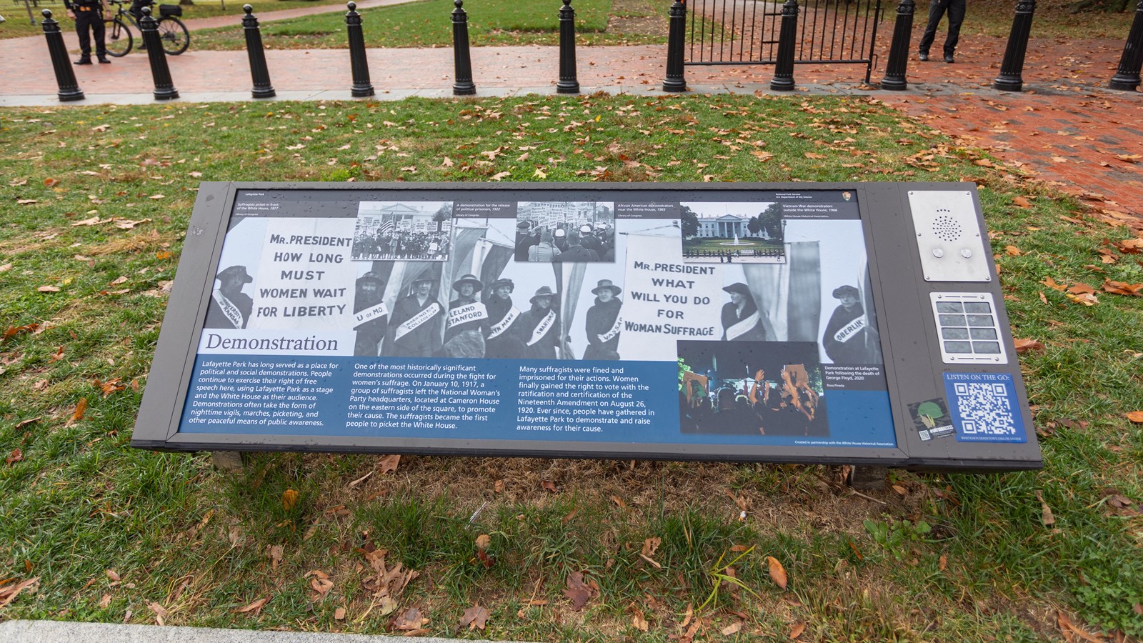 An exhibit panel with images of protestors in front of the White House.