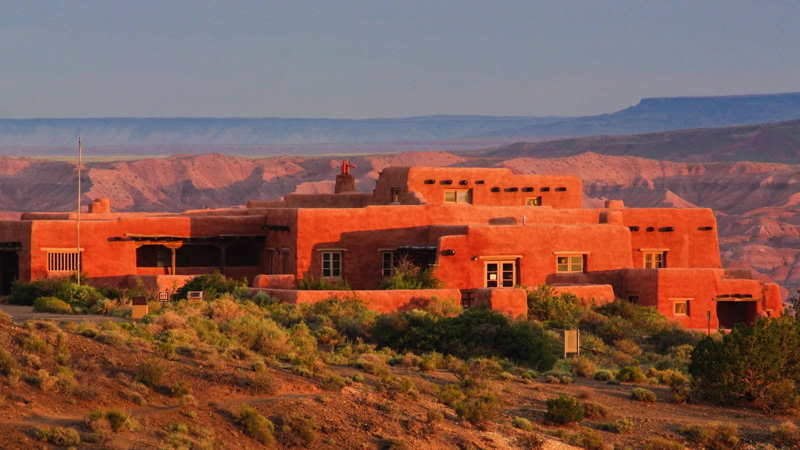 Historic Pueblo-Revival style building sitting on the edge of a mesa above the Painted Desert