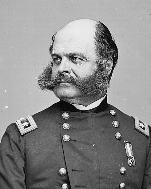 A man with large sideburns in a military outfit