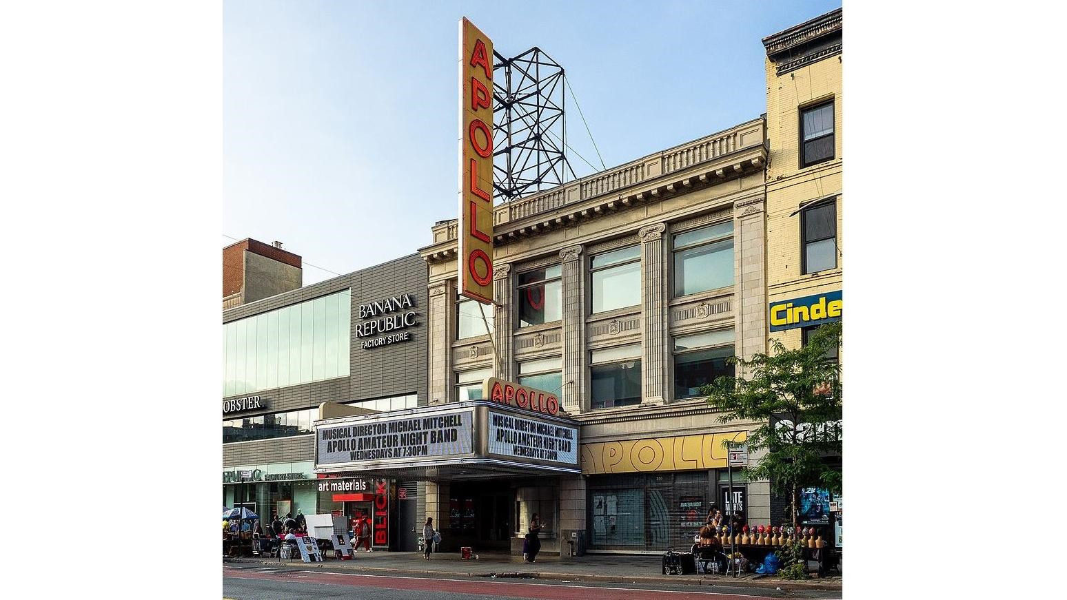 building attached to a main street corrido with a large luminescent sign across the entrance