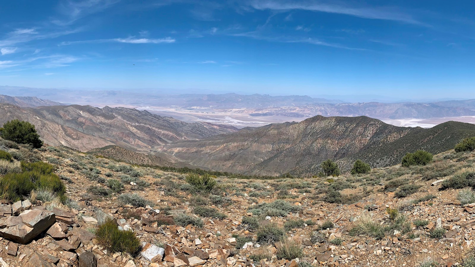 overlooking a valley with white salt and mountains beyond