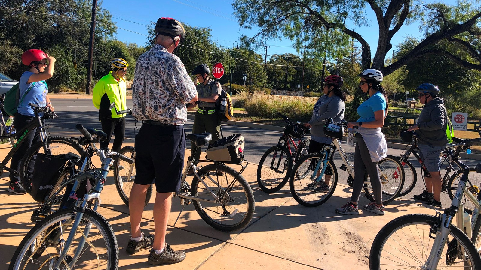 Bicyclists stand near the bike share station at the Hike & Bike trailhead