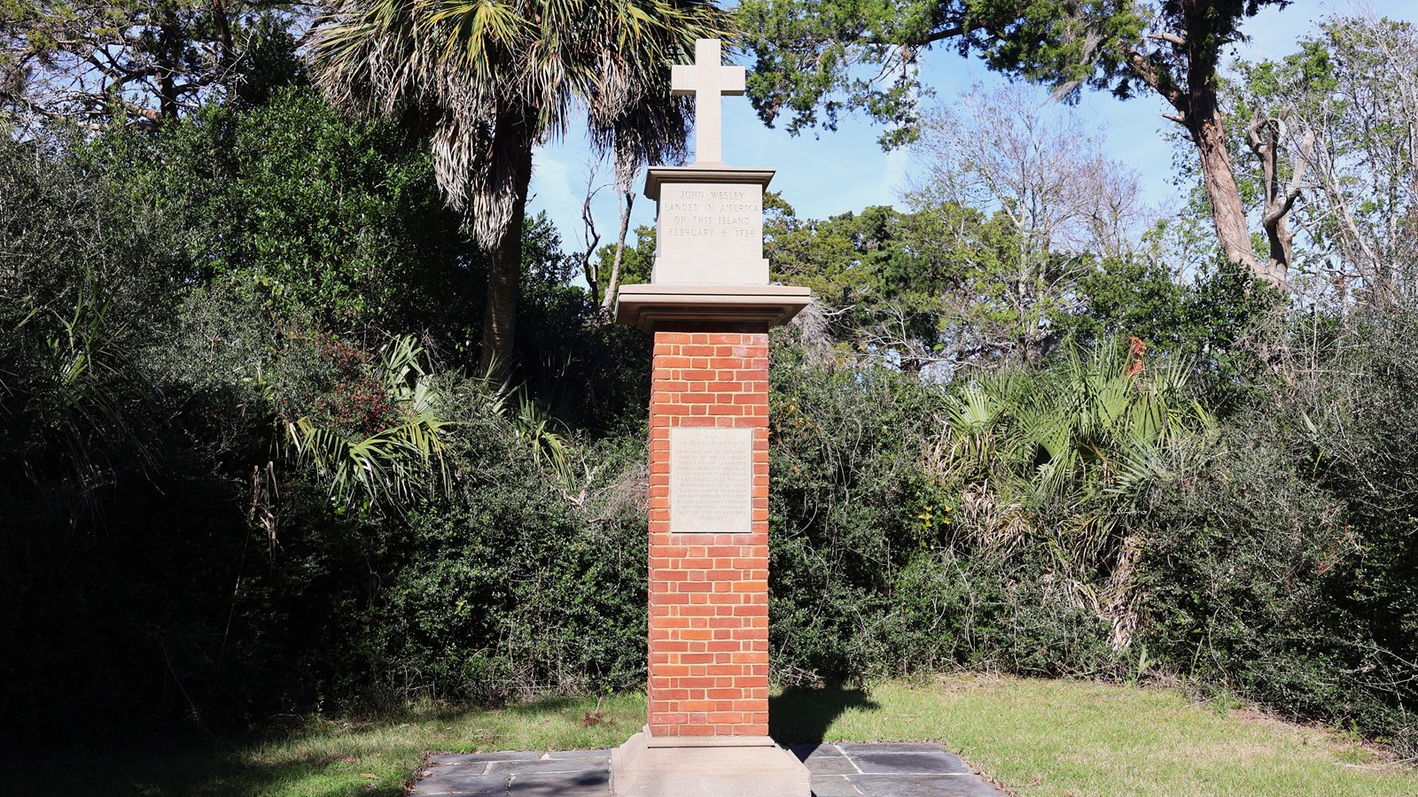 A brick column with a cross on top. 