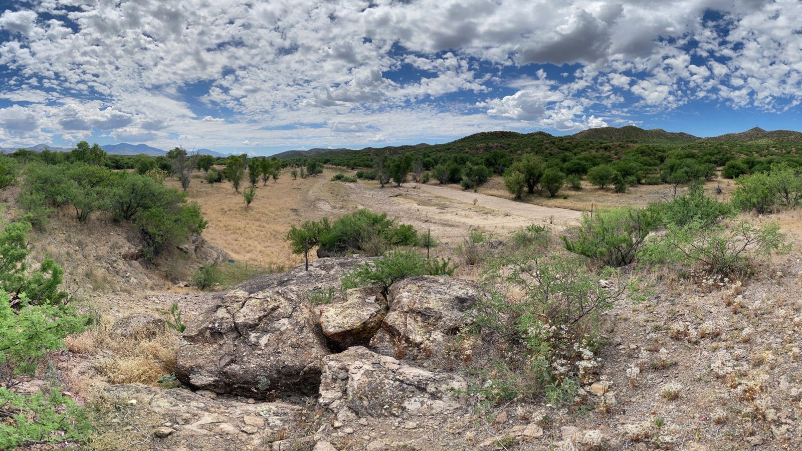 panoramic view of river valley from rock outcrop in near foreground