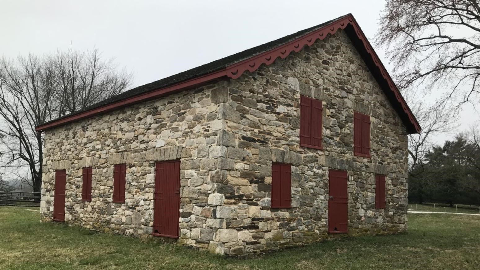 A modern day image of the stone mule barn on a cloudy day.