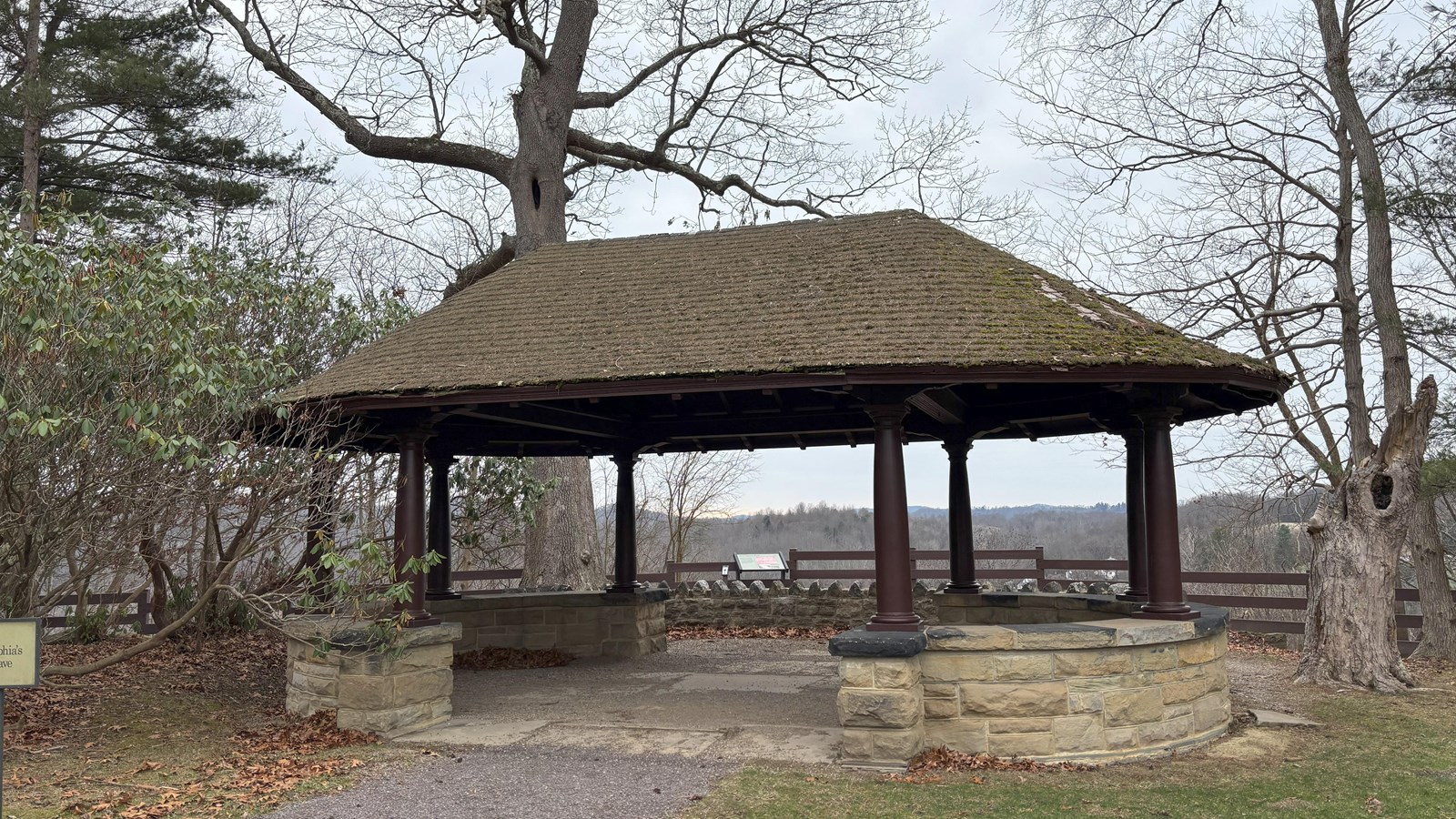 a stone structure with a roof near the overlook
