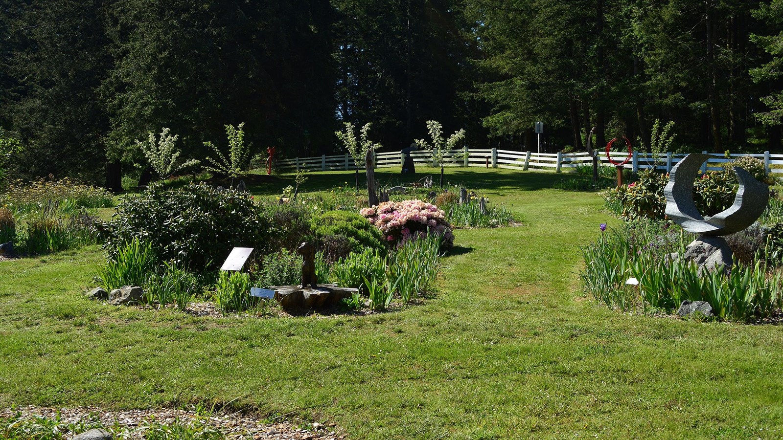 A manicured lawn filled with modern sculptures