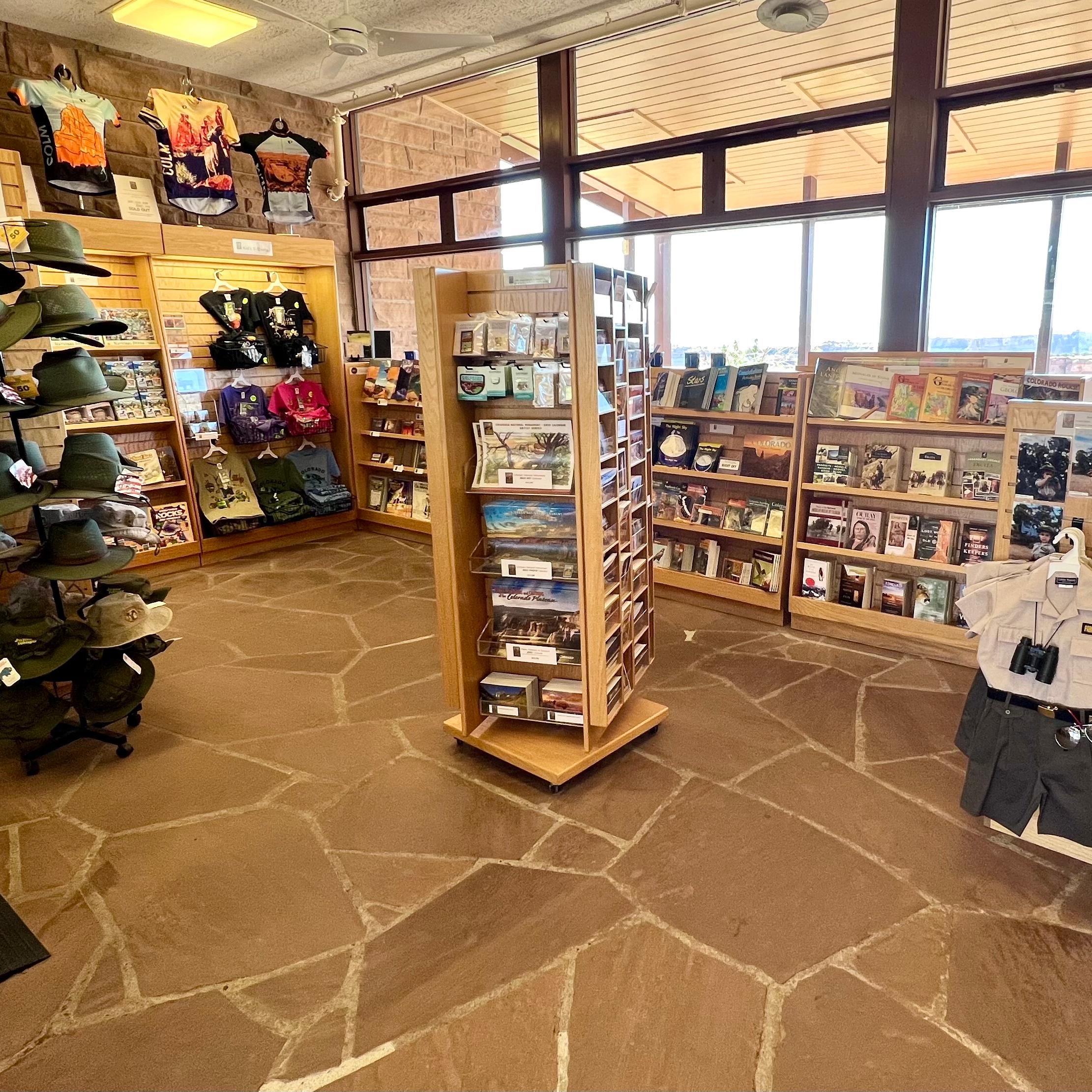 spacious store, wall-sized windows, various items for sale, hats, postcards, books, walking sticks