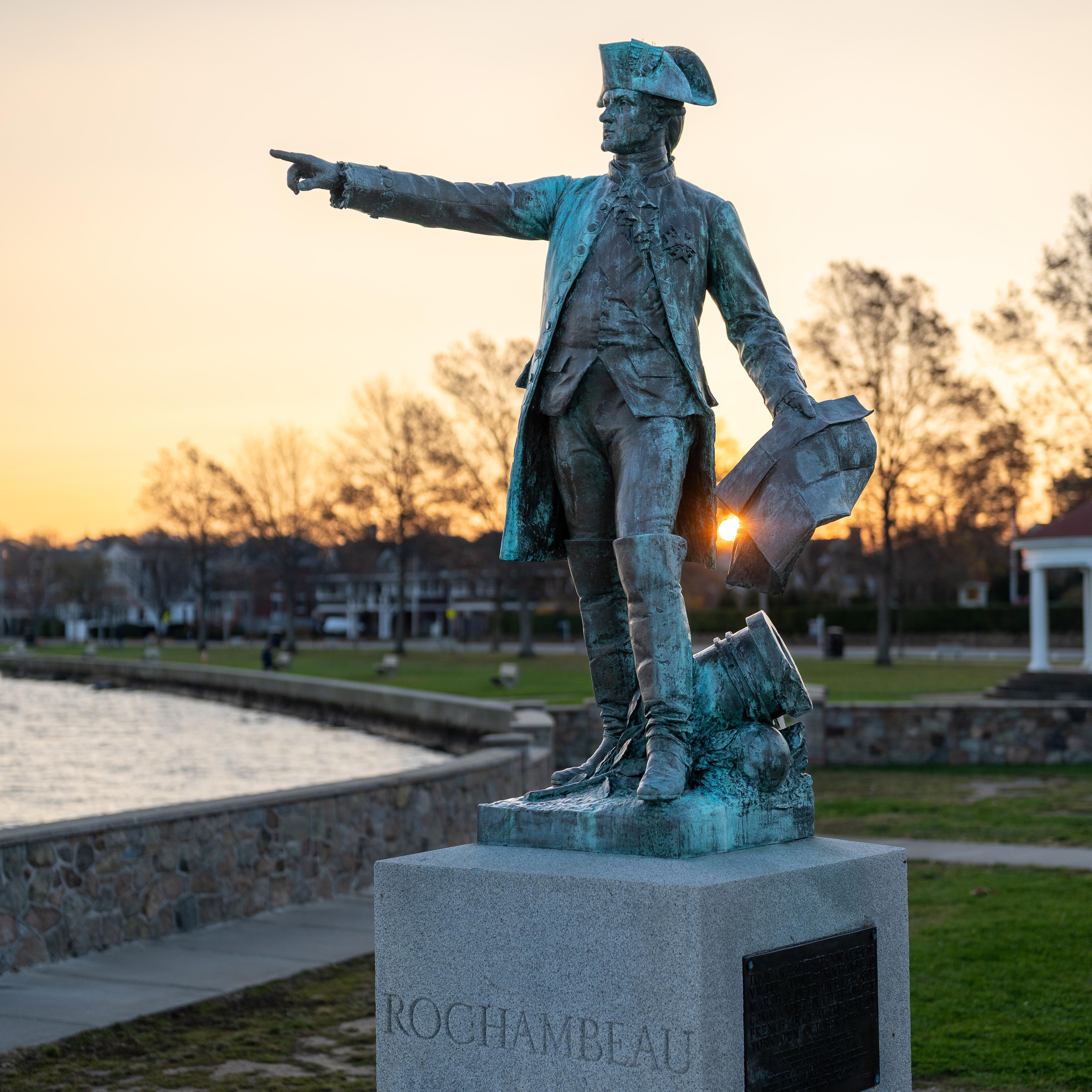Stone Rochambeau statue at King Park in Newport, RI with sunset behind. 