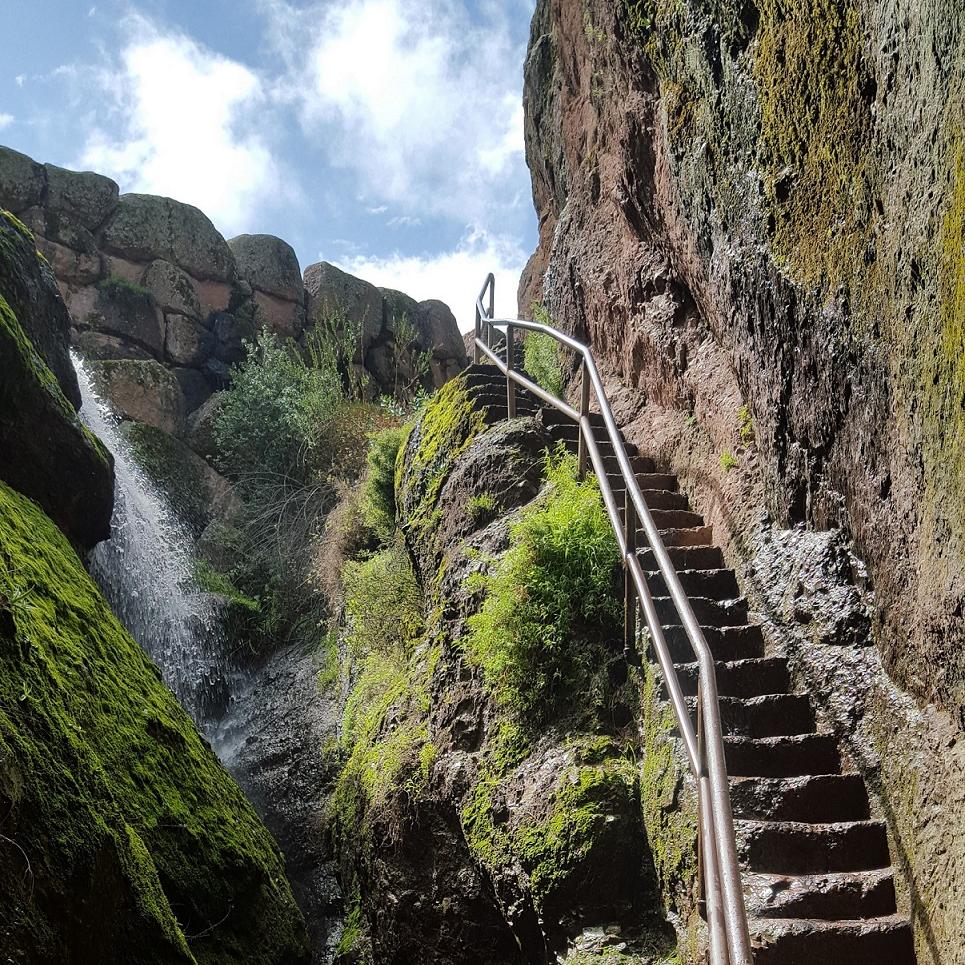 Narrow rock staircase edged out of rock wall  in a narrow rock canyon