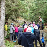 Park Ranger answers visitor questions on Isle Royale trail. 