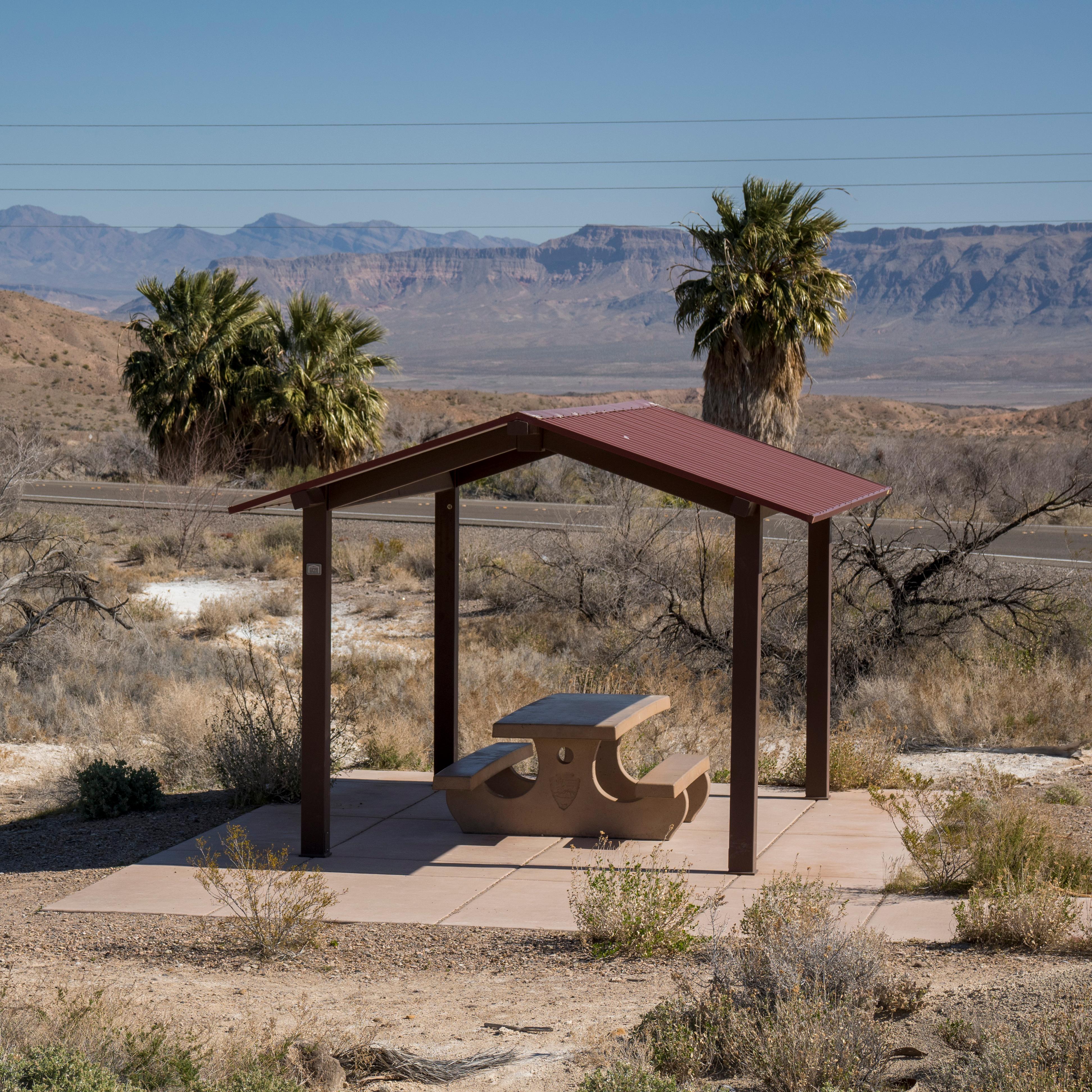 A picnic shelter with a desert landscape