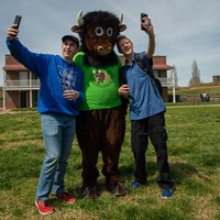 Visitors taking selfies with buddy bison.