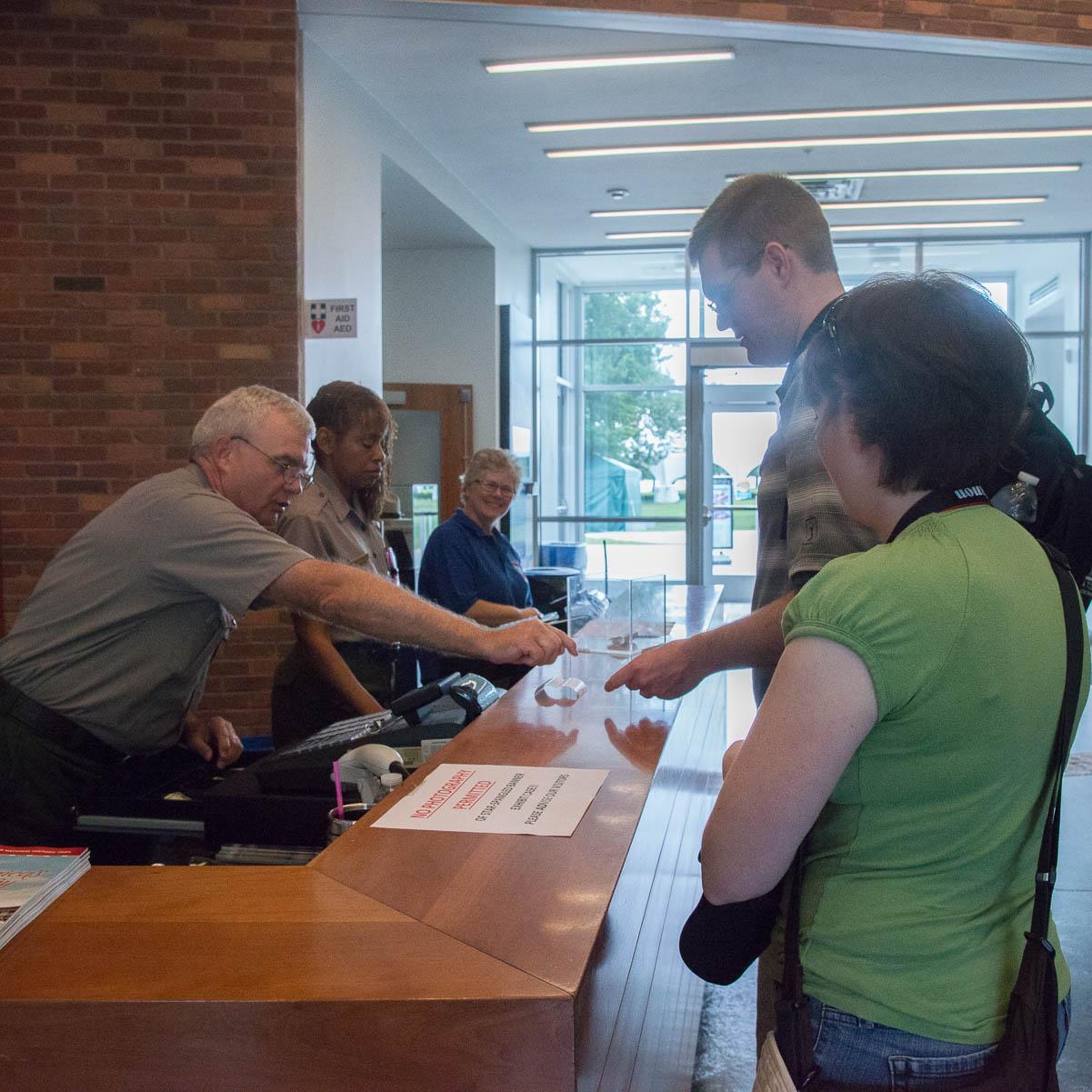 A ranger gives directions at the visitor center desk.