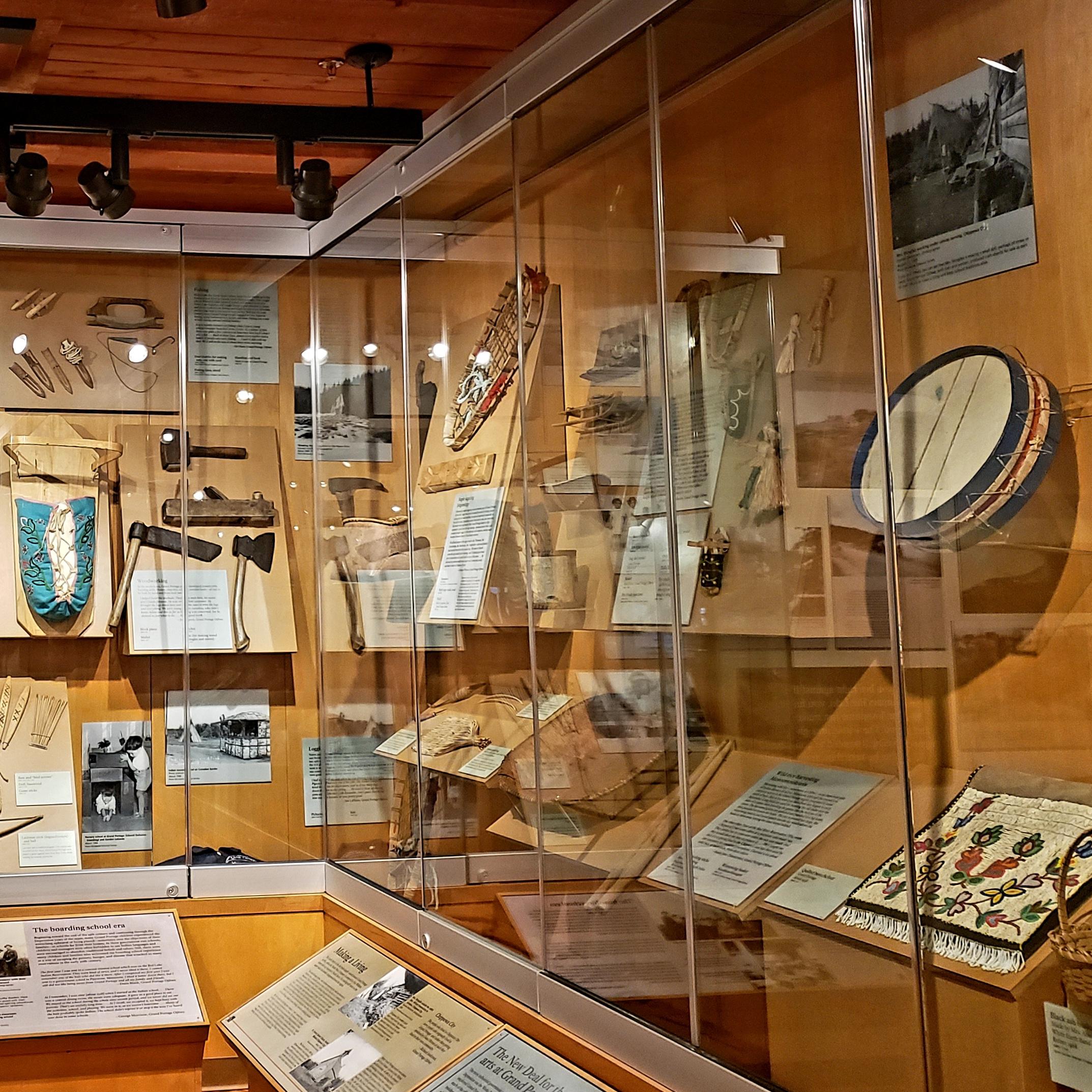 Interior view of a museum display of artifacts in a glass case.