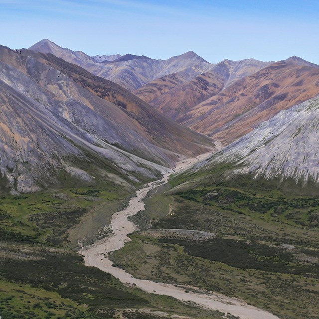 A range of mountains with a river winding towards them.
