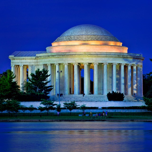 The Thomas Jefferson Memorial illuminated at dusk.