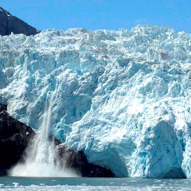 Chunks of ice calving off from a glacier into the ocean