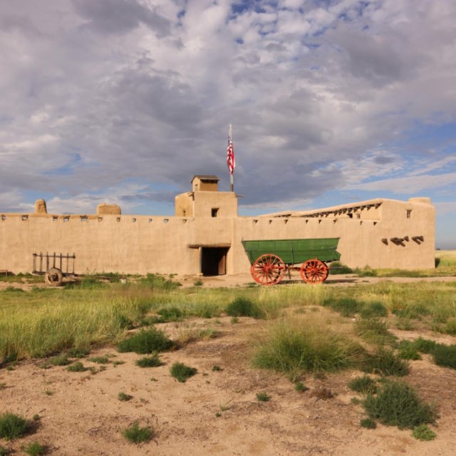 A fort with a wagon in front of it