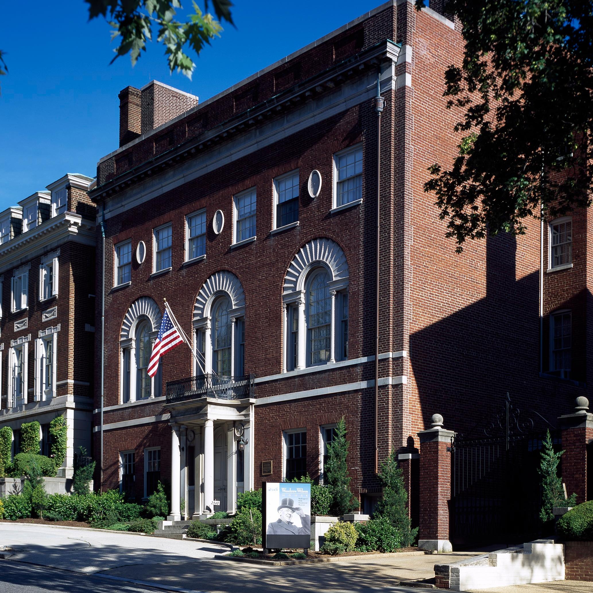 Photograph of outside of Woodrow Wilson House with street in foreground. 