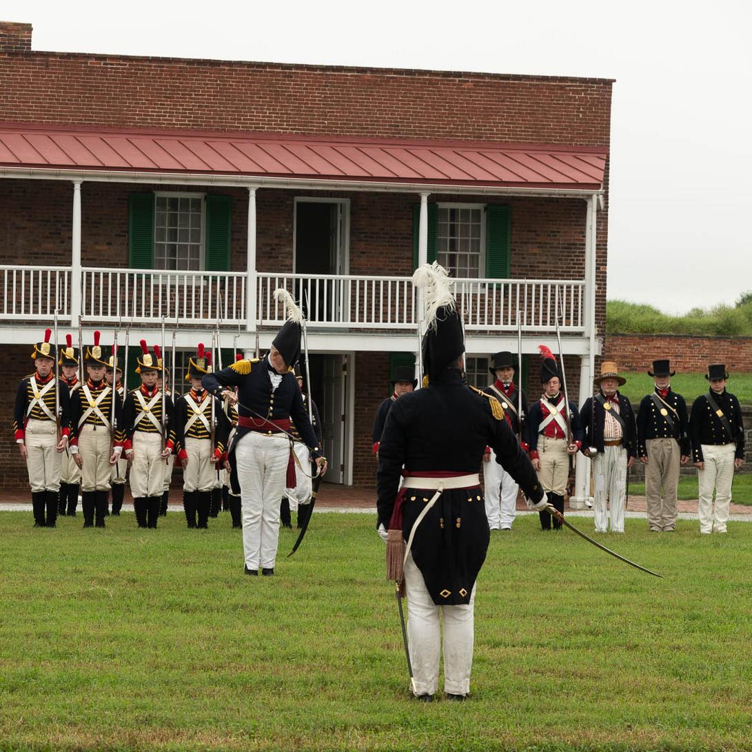 Living historians lining up in formation inside the historic star fort.