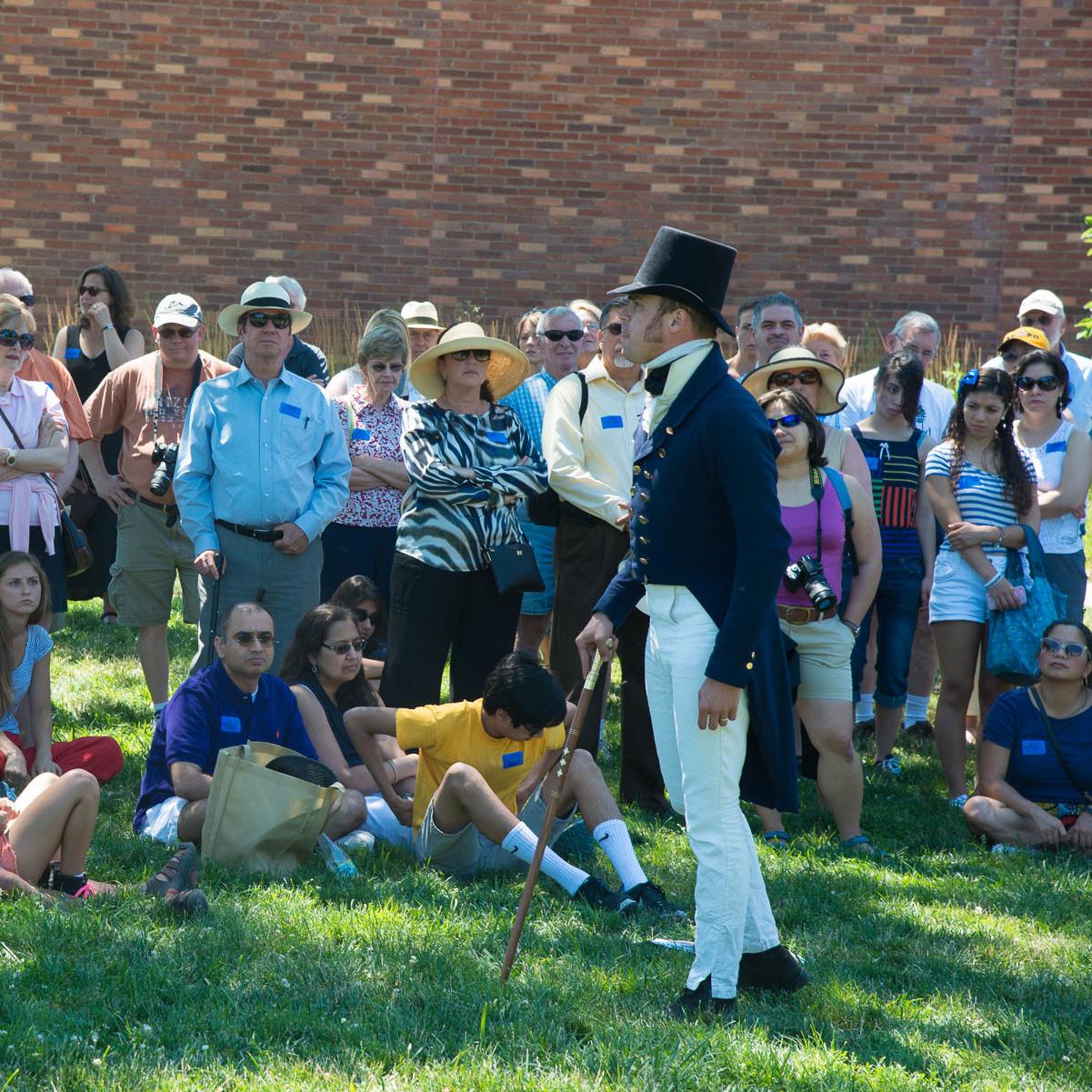 A living historian talks to a group of visitors.