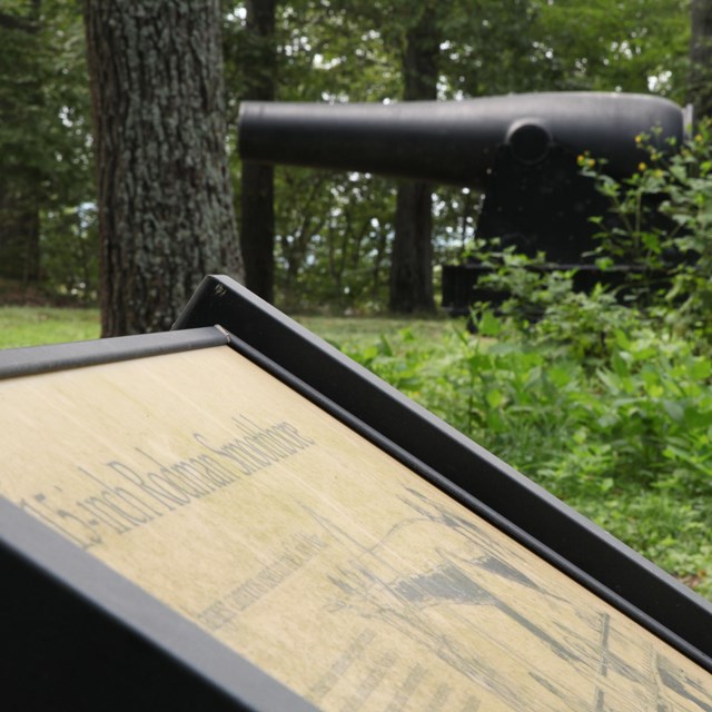 An educational sign and cannon at Fort Foote Park.