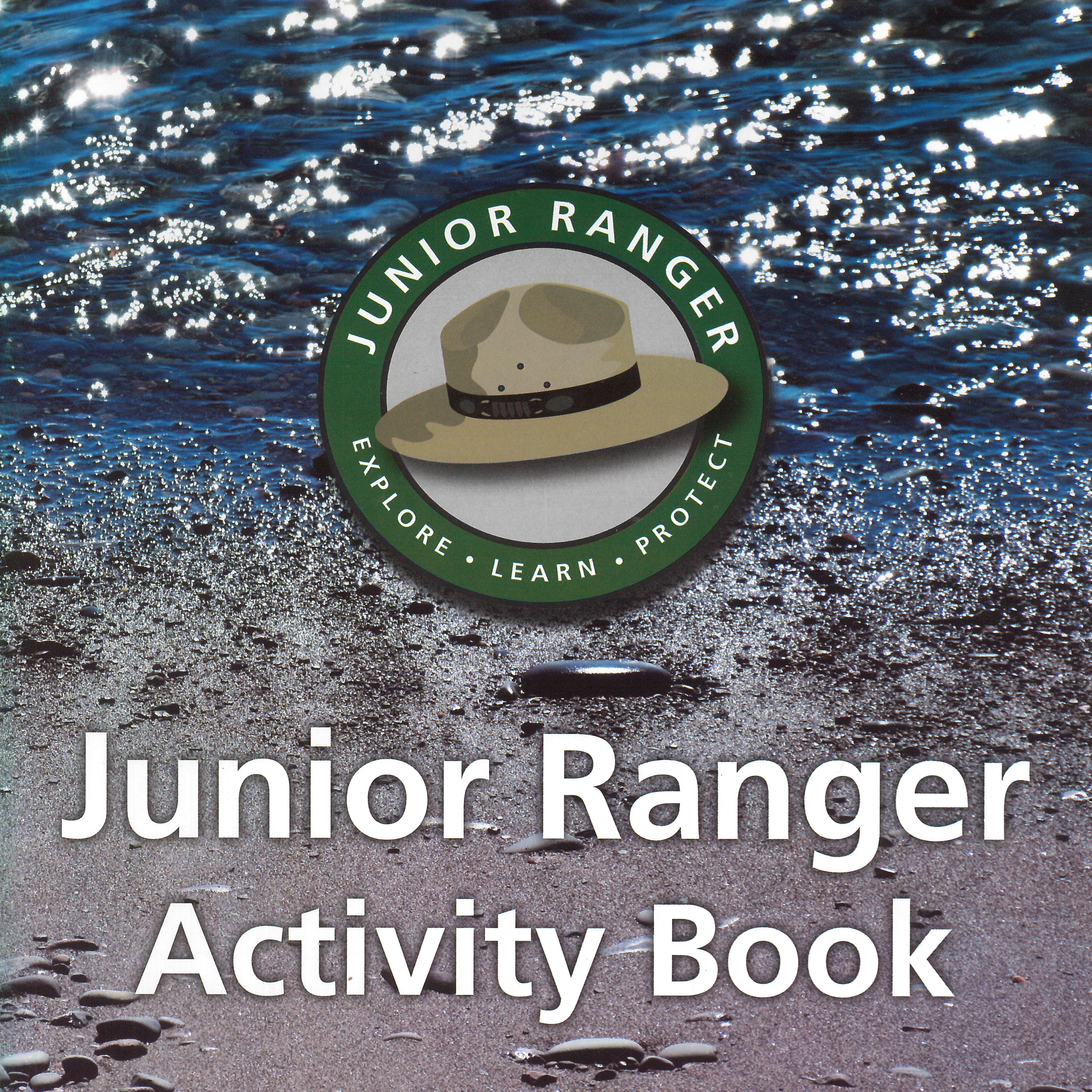 A photo of water and beach with a Junior Ranger logo superimposed in the center.