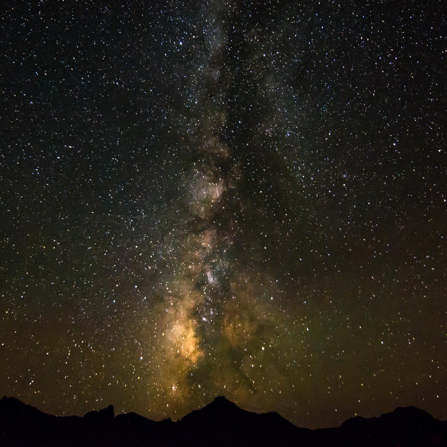 The Milky Way galaxy streaks across the sky.