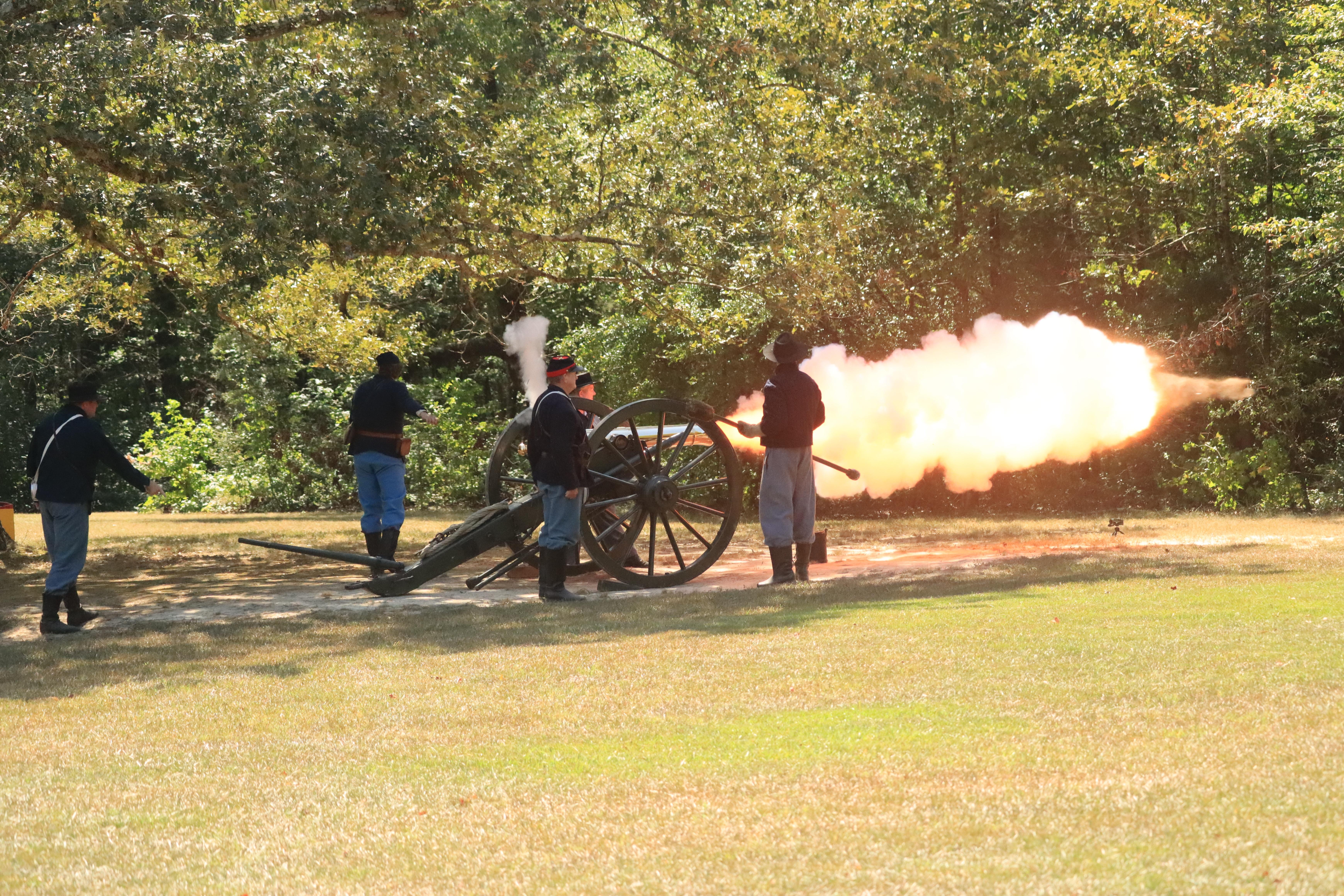 Fire belches from a bronze cannon during a demonstration