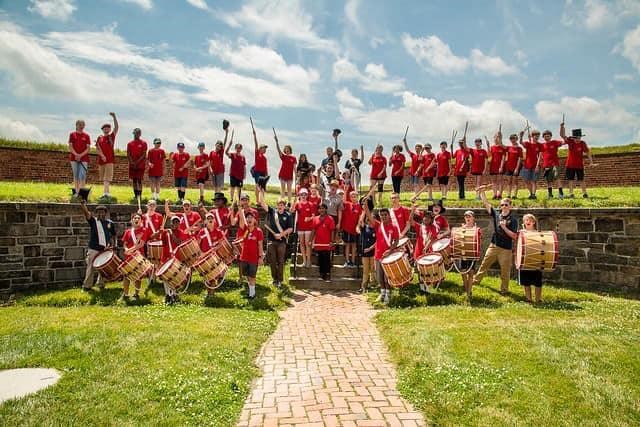 A group photo of fife and drum camp students on one of the bastions of the fort.