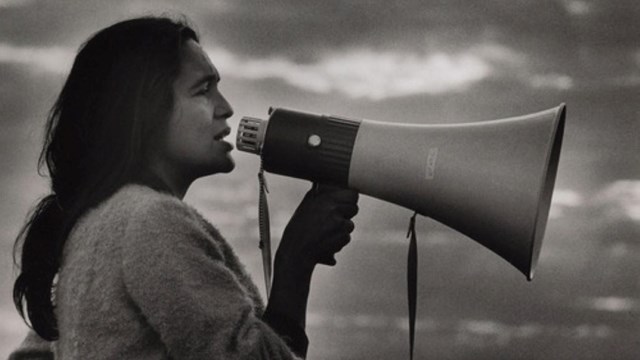 Image of Native American man speaking through bullhorn