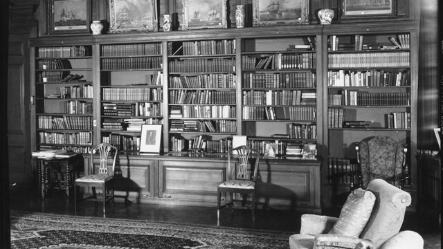 Library with built-in bookshelves filled with books.