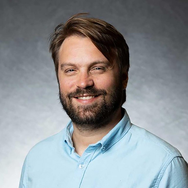 White man wearing a blue shirt