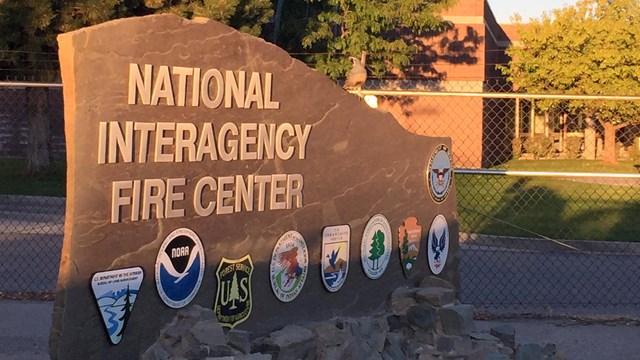 Sign for the National Interagency Fire Center with bureau/agency logos.