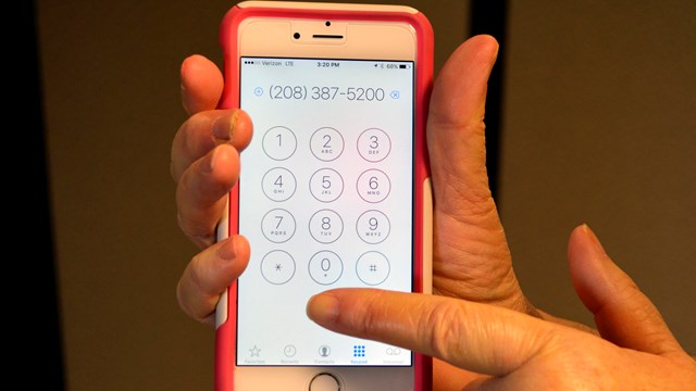 Person holding phone ready to dial phone number