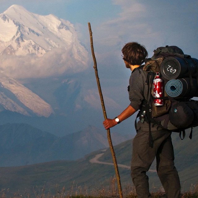 Backpacker looking out on Mt.Denali