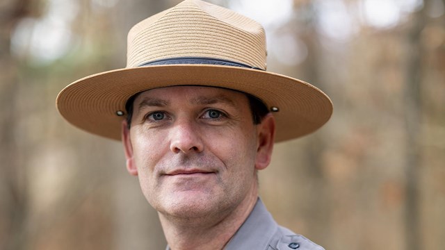 A man with park ranger uniform and hat.