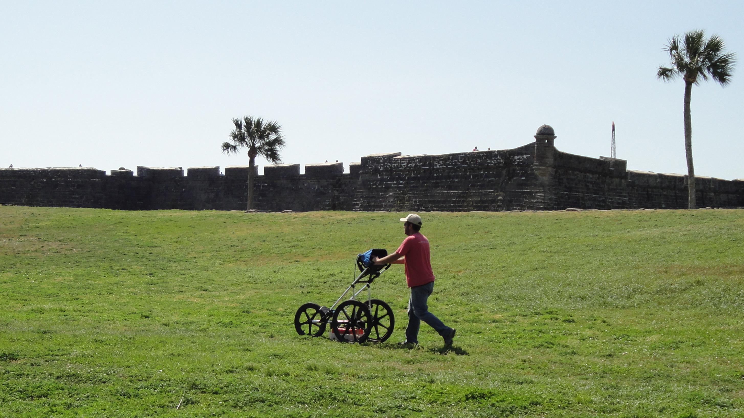 Archeologist standing in background behind a horse during Geophysical Survey