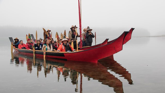 arrival of the canoes at the grand opening of the Huna Tribal House in Glacier Bay National Park