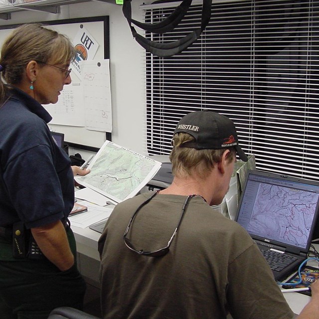 Wildland fire employees using GIS maps on the computer
