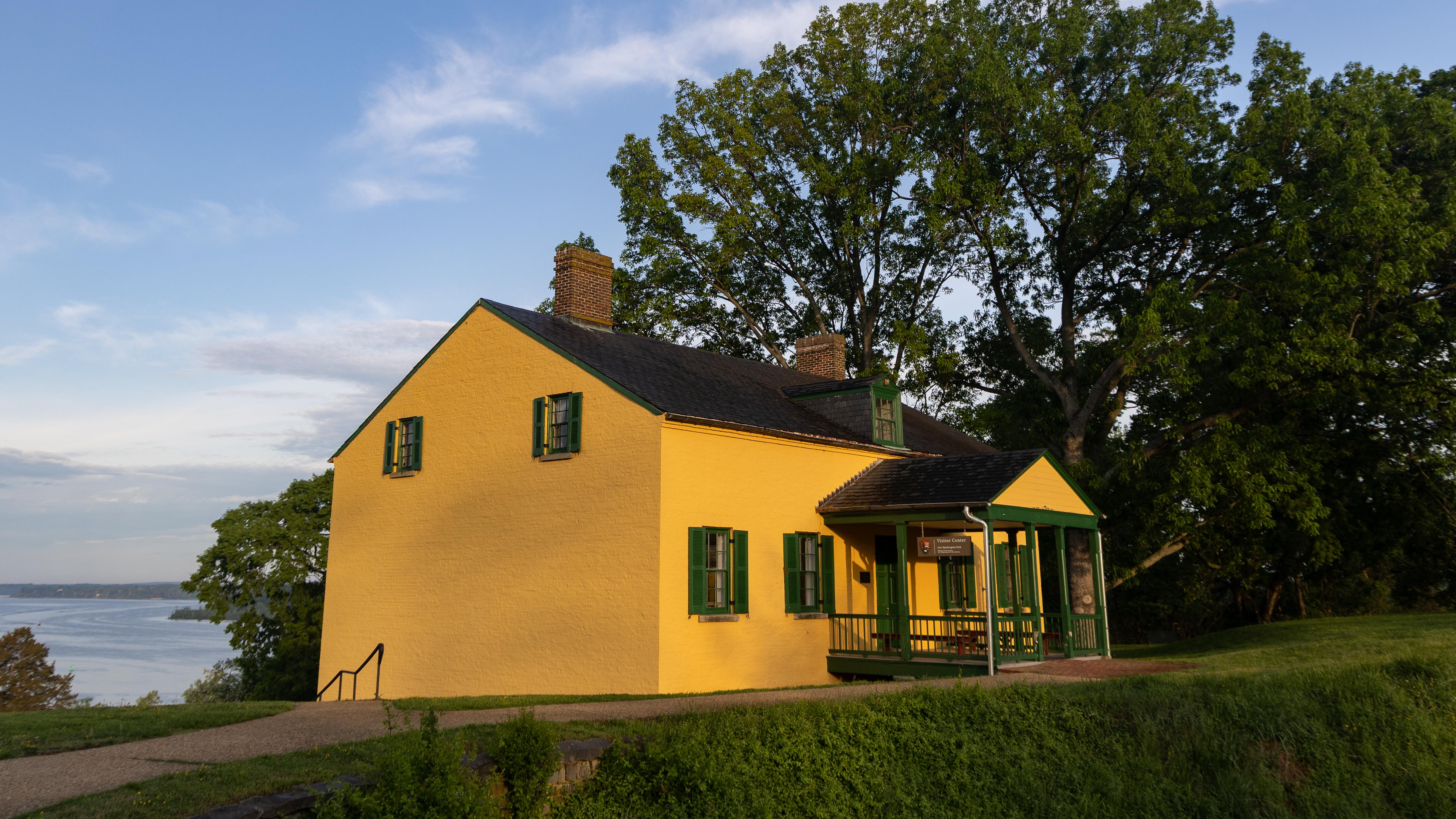 A yellow house overlooking the Potomac River from above.