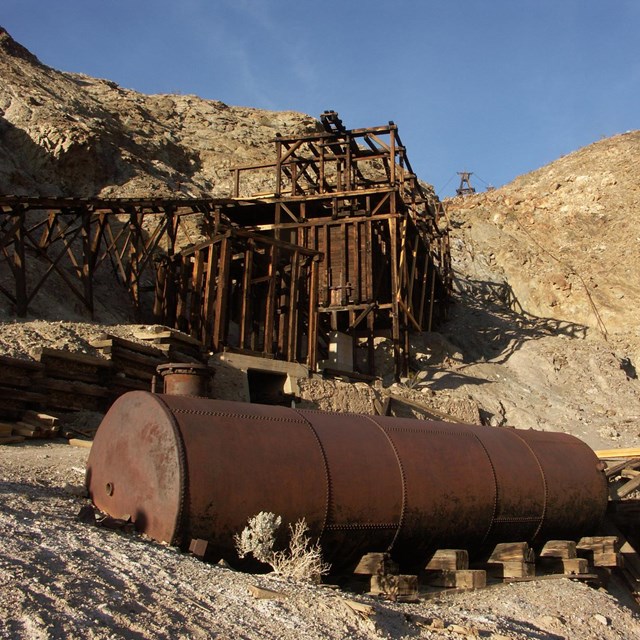 mine site with weathered equipment and buildings