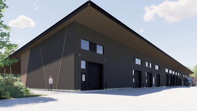 Large garage doors extend across the side of a long building. 