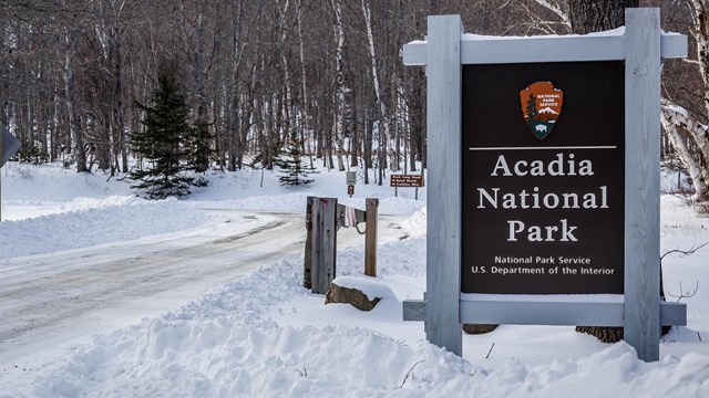 Park sign along a snow covered road