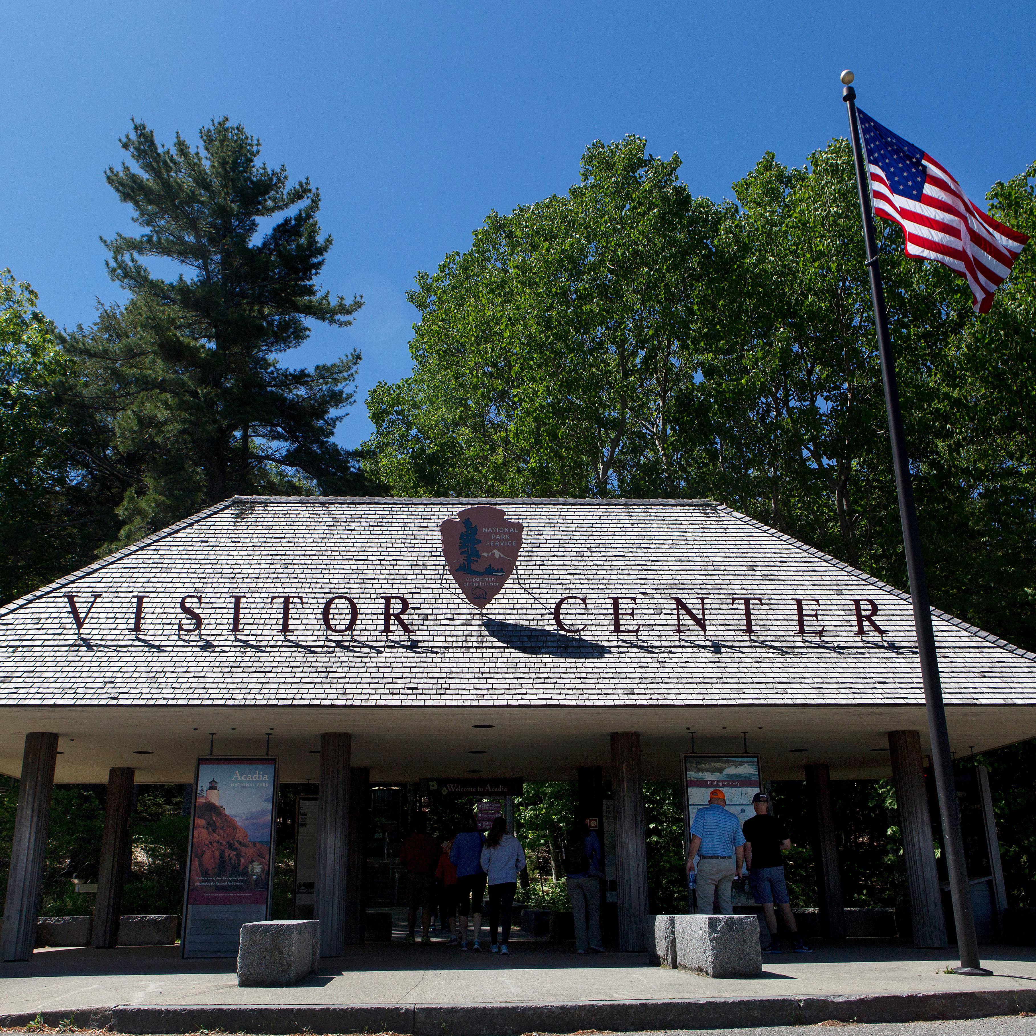 A wood shingled pavilion with a large sign reading 