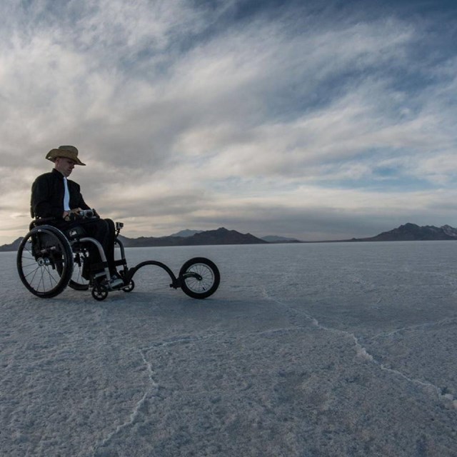 Man in a wheelchair on the salt flats of death valley.