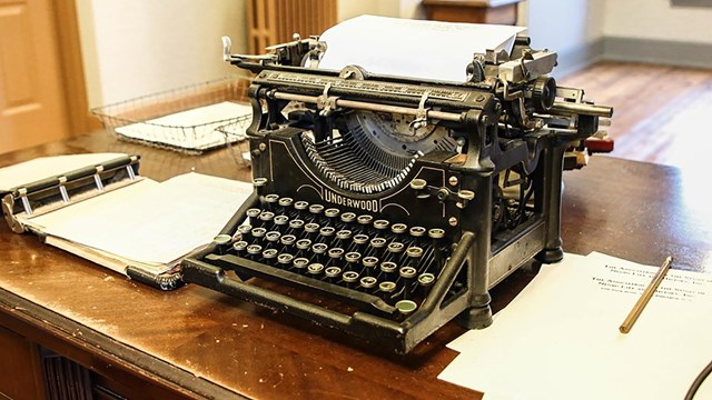 historic typewriter on a wooden desk