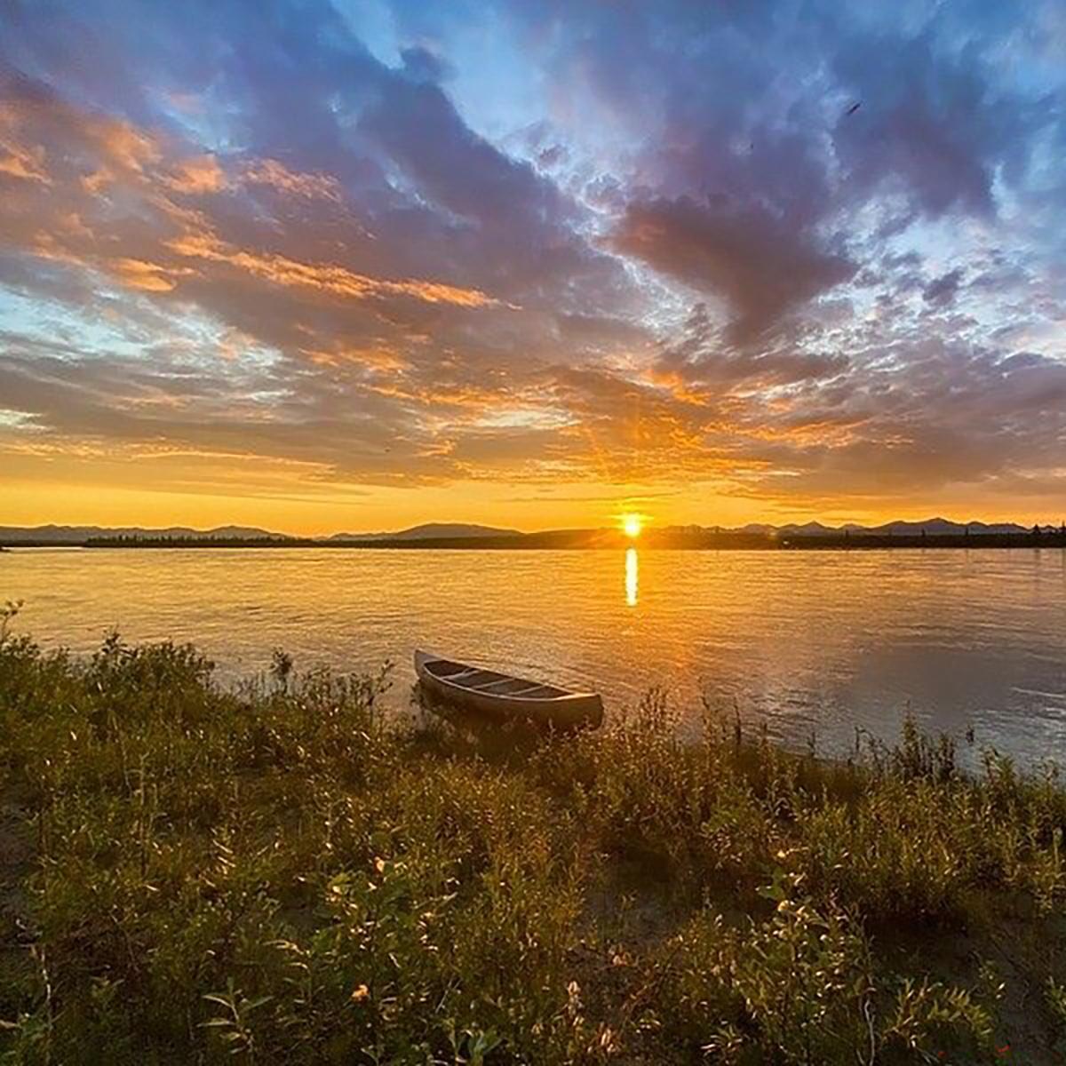Sunrise on the Noatak River with a canoe in the foreground.